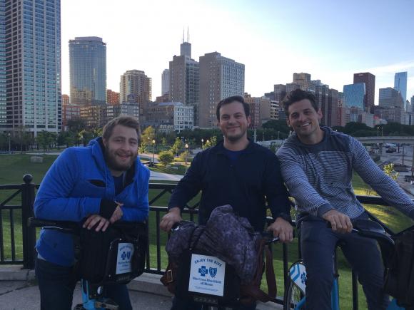 Jan, Jonathan, and Kevin smile for the cameras while riding their bikes through Chicago.