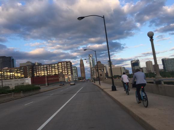 The team rides their bikes in the Chicago streets.