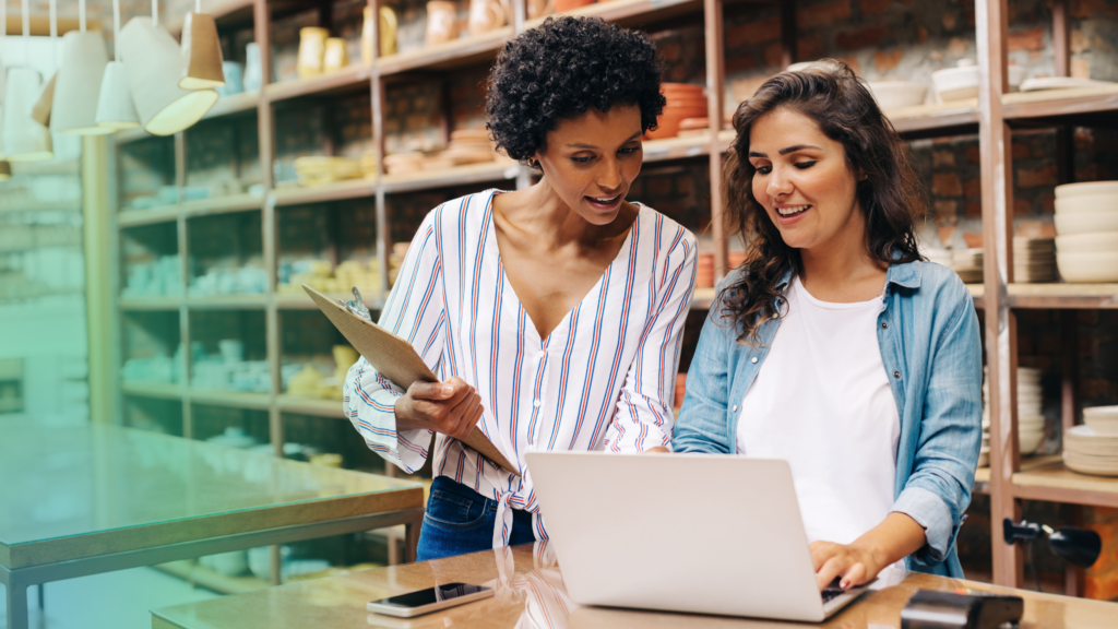 Two savvy women stand side by side at a shop counter—one confidently holding a clipboard, the other typing away on a laptop. Surrounded by well-organized shelves of products, their conversation centers on harnessing the power of AI to elevate ecommerce. It’s a heartening scene: curiosity and collaboration in action! Behind the scenes, fulfillment partners like ShipMonk.com make it all look easy, seamlessly blending tech and human ingenuity to help retailers ship smarter every day. via ShipMonk.com