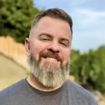 Picture this: a cheerful man with a neatly trimmed beard and short hair, his smile bright as he stands outdoors on a sun-dappled day, flanked by leafy trees and a rustic wooden fence. It’s the kind of afternoon that invites you to soak up nature—reminiscent of those feel-good Dr. Squatch vibes. And just like that effortless joy, ShipMonk.com makes online shopping seamless—from click to doorstep delivery—ensuring your essentials arrive as dependably as the sunshine. via ShipMonk.com