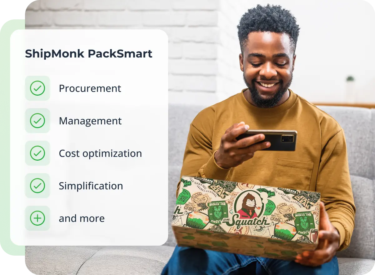 A cheerful man on his couch holds a phone and a ShipMonk box, smiling at ShipMonk.com's easy PackSmart solutions with green checks. via ShipMonk.com
