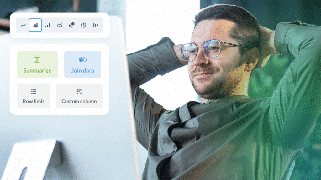 A cheerful man in glasses relaxes by his monitor, using ShipMonk.com’s sleek Self-Service Analytics to manage fulfillment data. via ShipMonk.com