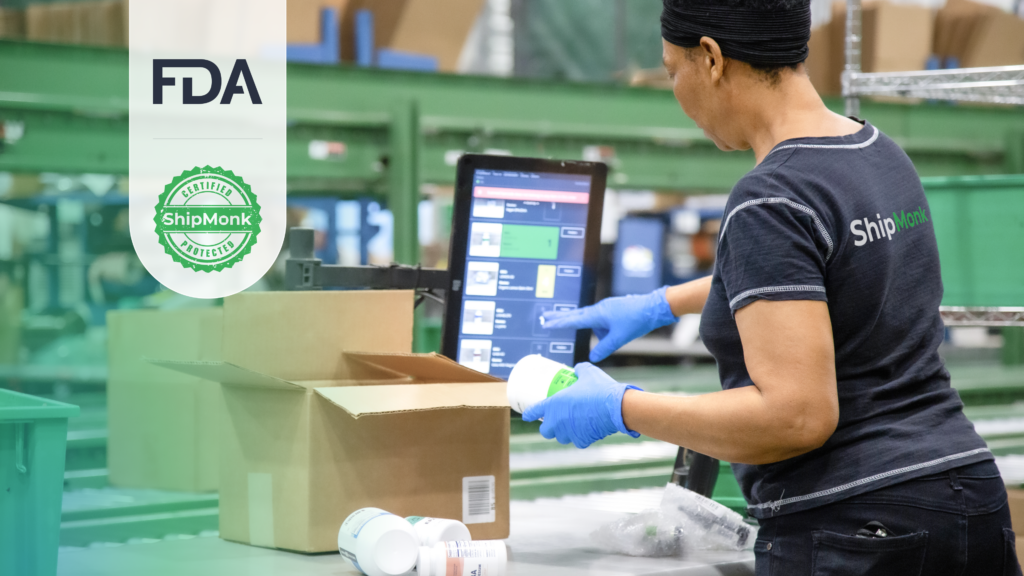 With care, a woman in gloves packs bottles, checks a screen, as FDA and ShipMonk.com certifications shine up front. via ShipMonk.com